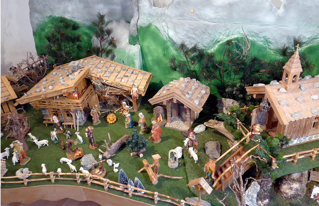 Krippe mit vielen Schafen und Kirche im alpenländischen Stil